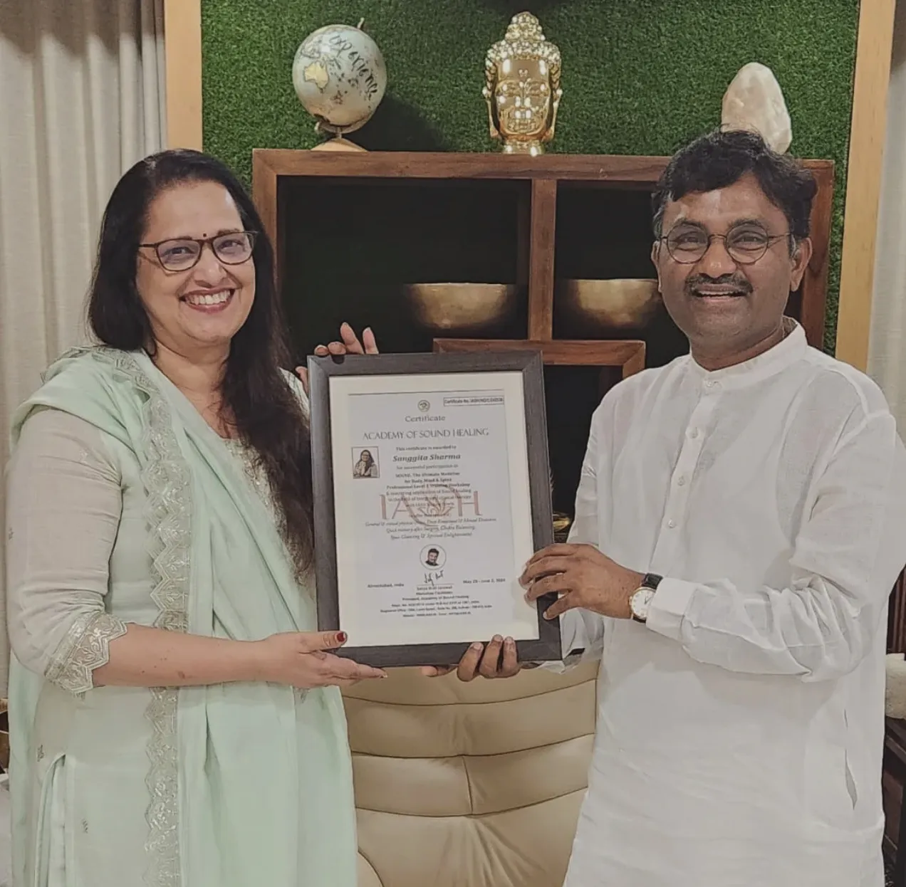 Sanggita Sharma receiving her certificate from the Academy of Sound Healing
