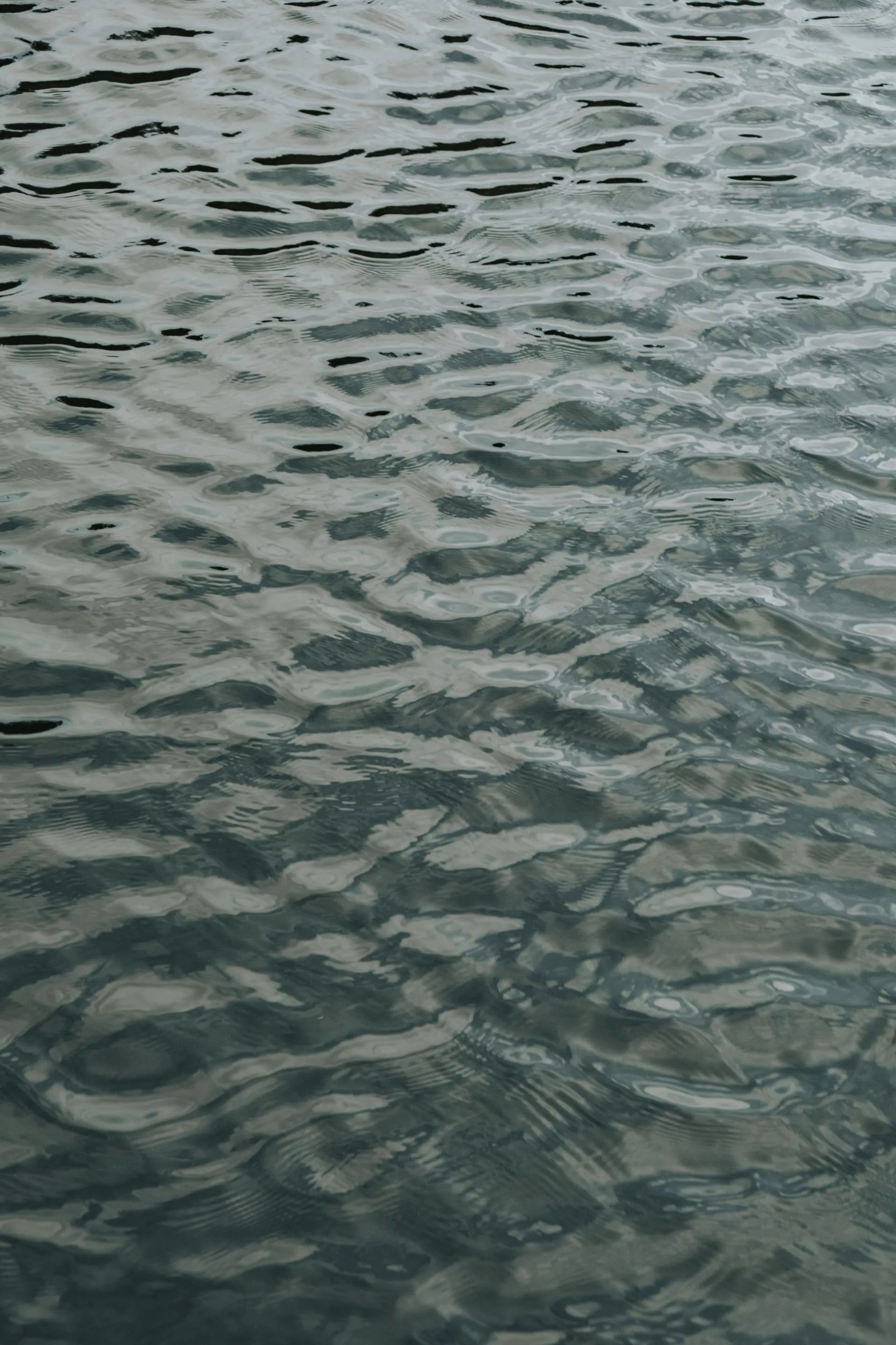 Soft ripples moving across a calm water surface